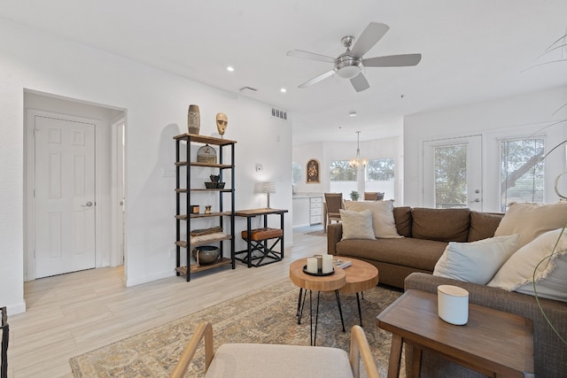 living room featuring ceiling fan and light wood-type flooring