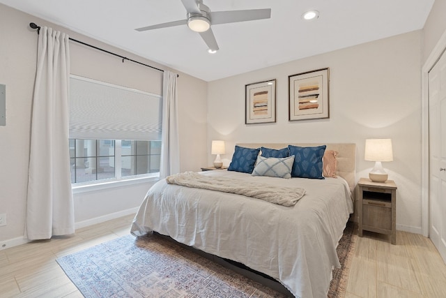 bedroom with ceiling fan and light hardwood / wood-style floors