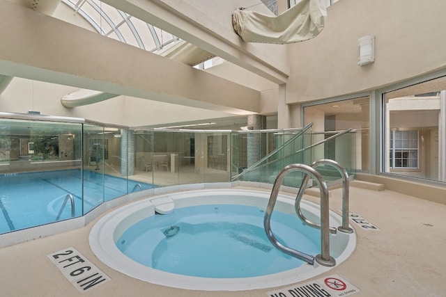 view of swimming pool with an indoor in ground hot tub