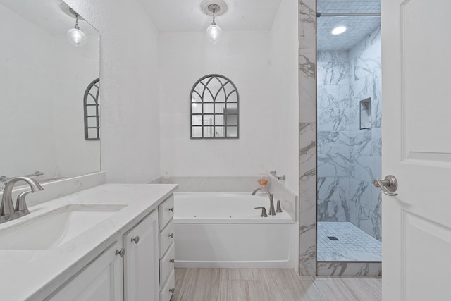 bathroom featuring vanity and plus walk in shower