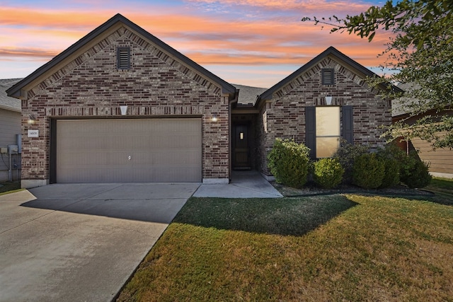 view of front of house with a yard and a garage