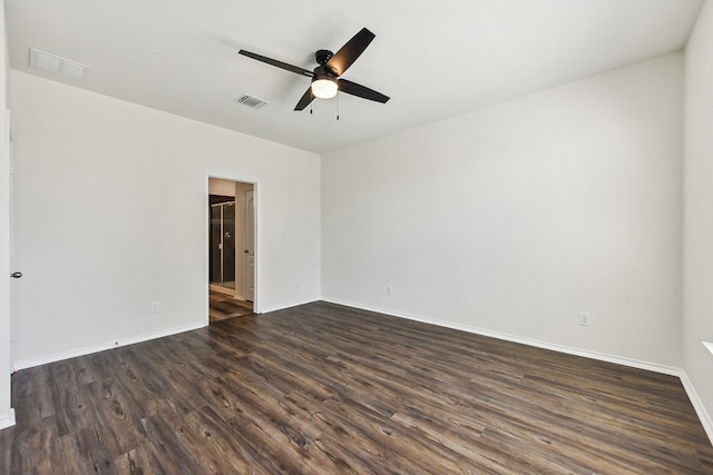 spare room featuring dark wood-type flooring and ceiling fan