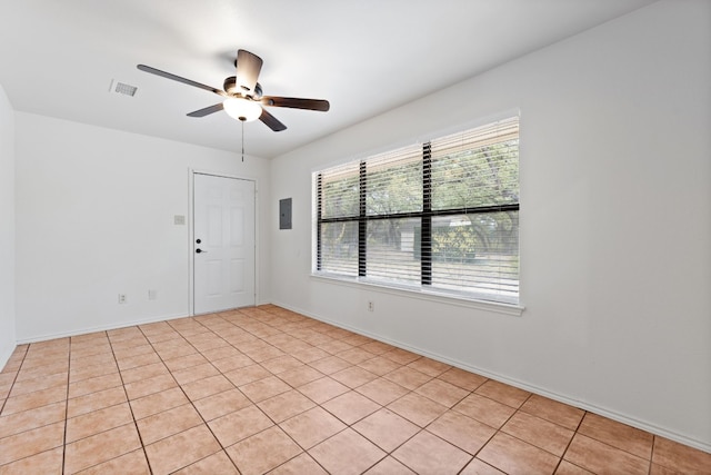 tiled empty room with ceiling fan