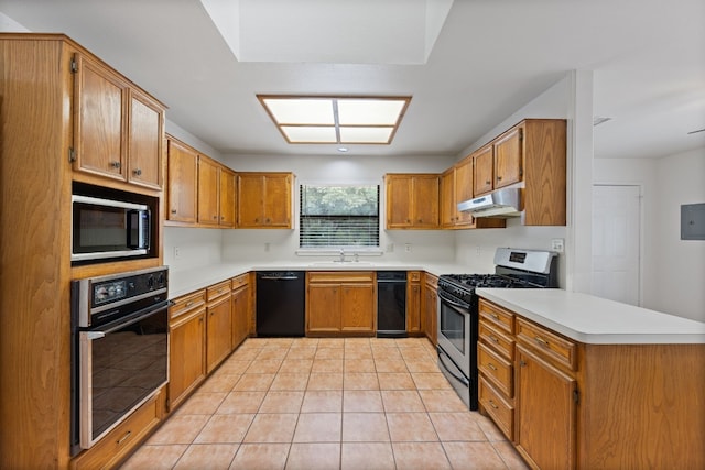 kitchen featuring light tile patterned flooring, black appliances, and sink