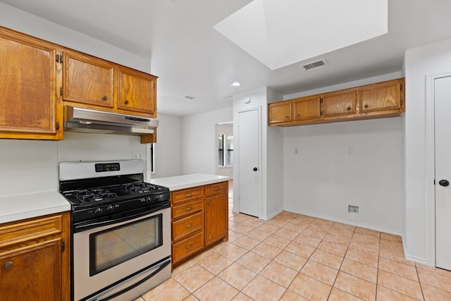 kitchen featuring gas stove and light tile patterned floors