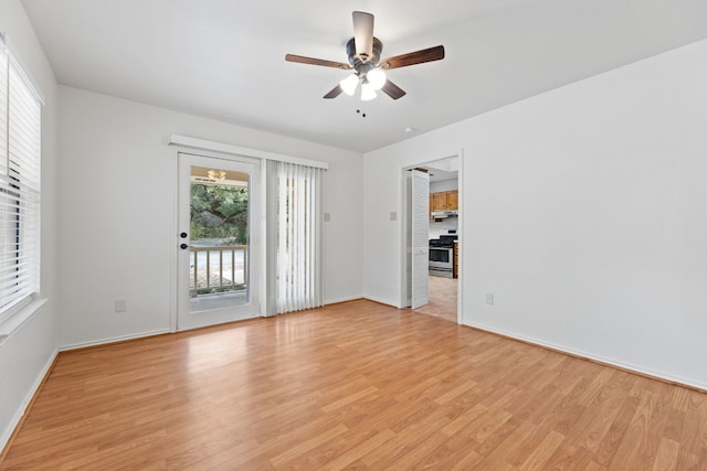 spare room featuring light hardwood / wood-style floors and ceiling fan