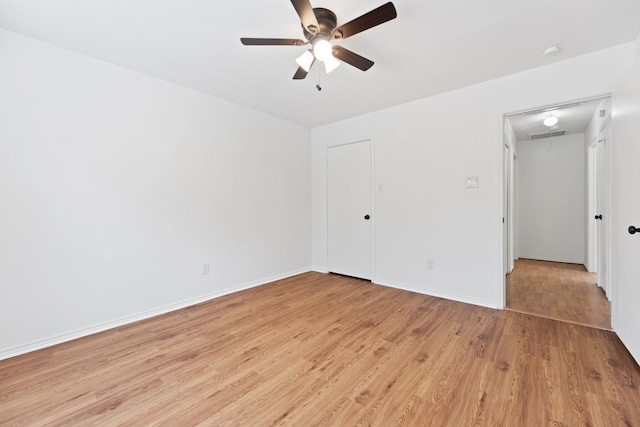 spare room with light wood-type flooring and ceiling fan