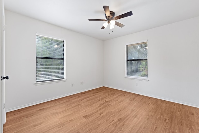 empty room featuring light wood-type flooring and ceiling fan