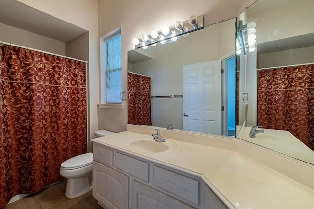 bathroom with vanity, toilet, and tile patterned floors