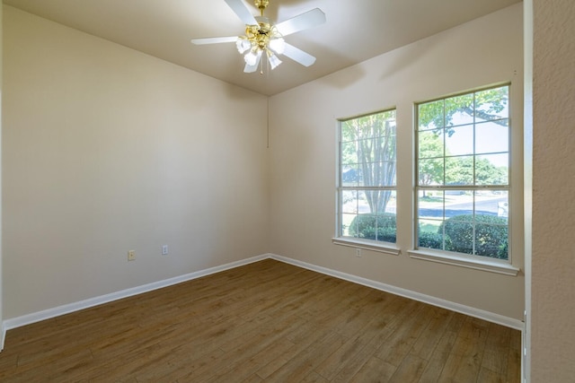 empty room with ceiling fan and dark hardwood / wood-style floors