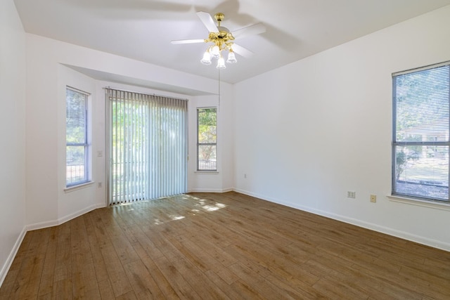 empty room featuring dark wood-type flooring and ceiling fan