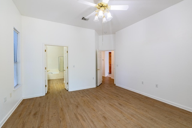 unfurnished bedroom with light hardwood / wood-style floors, connected bathroom, and ceiling fan