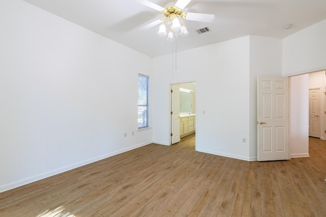 unfurnished bedroom featuring connected bathroom, ceiling fan, and light hardwood / wood-style floors