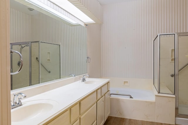 bathroom with vanity, hardwood / wood-style flooring, and plus walk in shower