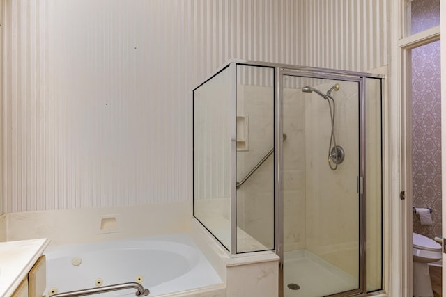 full bathroom featuring vanity, separate shower and tub, and toilet