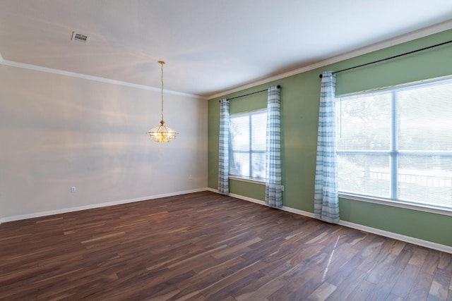 spare room featuring crown molding and dark hardwood / wood-style floors