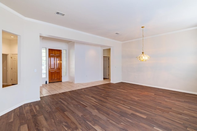 empty room featuring crown molding and light wood-type flooring