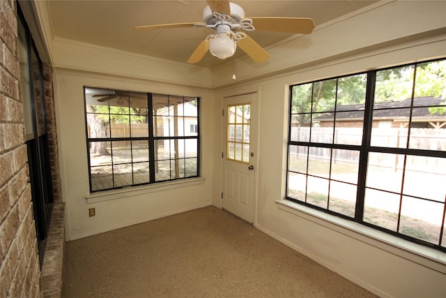 entryway featuring crown molding, brick wall, and a wealth of natural light