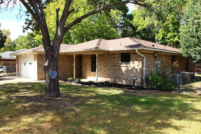 single story home with a front lawn, brick siding, an attached garage, and fence