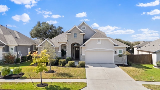 view of front of property featuring a front yard and a garage