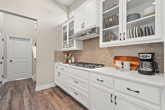 kitchen featuring stainless steel gas cooktop, dark hardwood / wood-style floors, tasteful backsplash, and white cabinetry