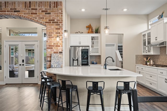 kitchen featuring appliances with stainless steel finishes, dark hardwood / wood-style flooring, sink, and a wealth of natural light