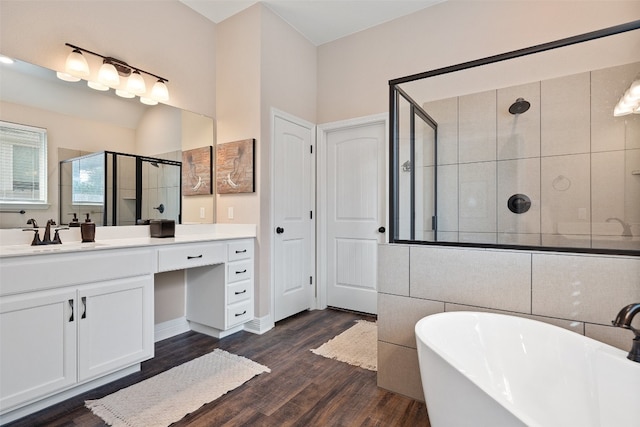 bathroom featuring vanity, plus walk in shower, and wood-type flooring