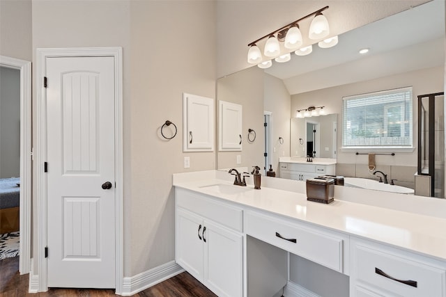 bathroom with vanity, hardwood / wood-style flooring, lofted ceiling, and a shower with door