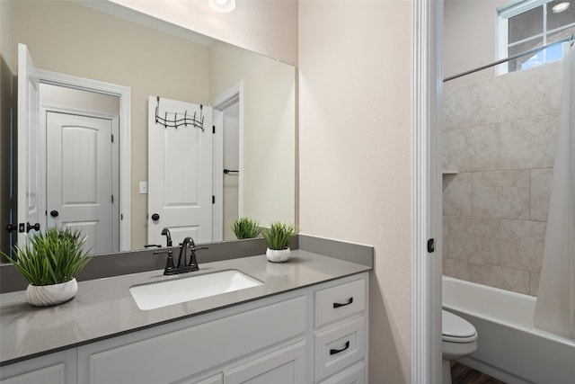 full bathroom with vanity, shower / bath combo, and toilet