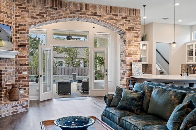 925 Overstreet Ln, Leander, TX 78641 - living area featuring plenty of natural light, wood finished floors, and stairway