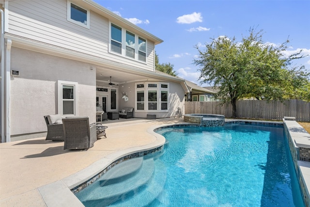 view of pool with an in ground hot tub, a patio, and ceiling fan