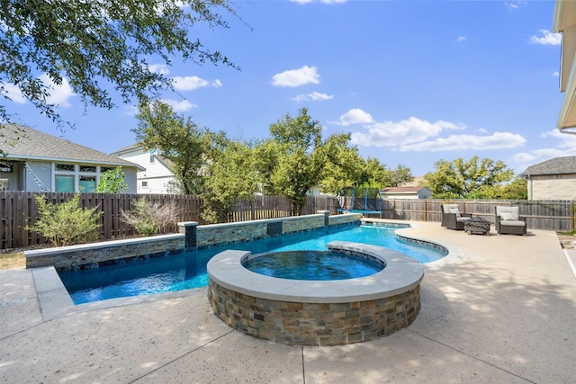 view of swimming pool featuring an in ground hot tub and a patio area