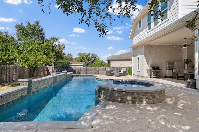 view of swimming pool featuring a patio, an in ground hot tub, and a grill