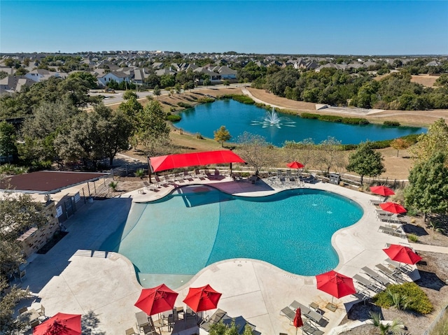 view of pool with a water view and a patio area