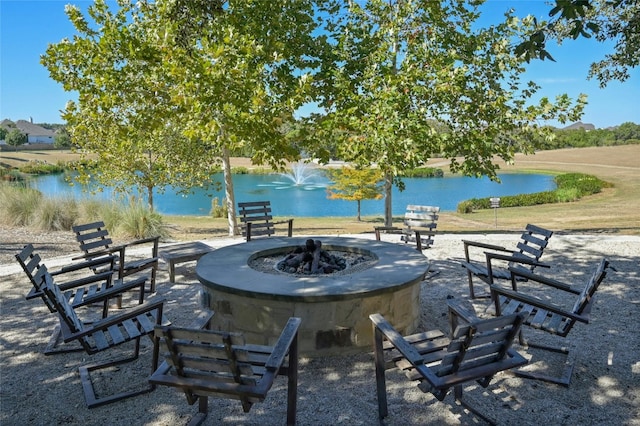 view of patio / terrace featuring a water view and an outdoor fire pit