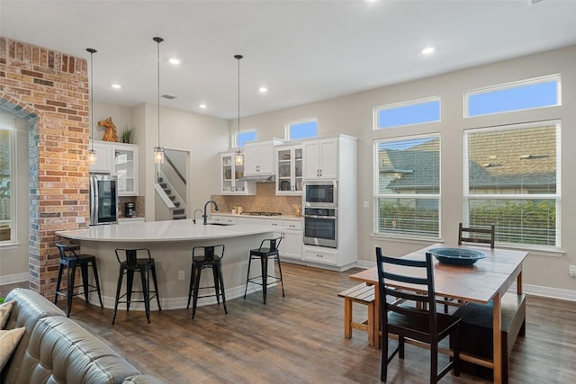925 Overstreet Ln, Leander, TX 78641 - kitchen featuring stainless steel oven, smart refrigerator, built in microwave, dark wood-type flooring, and decorative backsplash