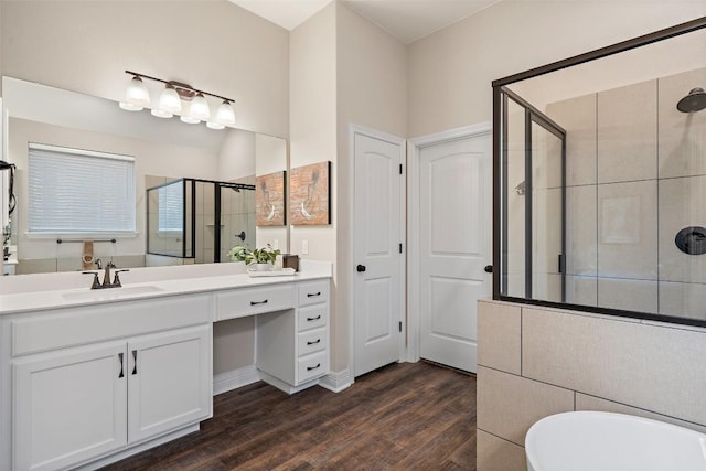 925 Overstreet Ln, Leander, TX 78641 - bathroom with a stall shower, wood finished floors, vanity, and a freestanding tub