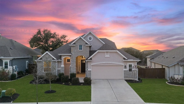 view of front facade featuring a garage, stone siding, concrete driveway, and a front yard