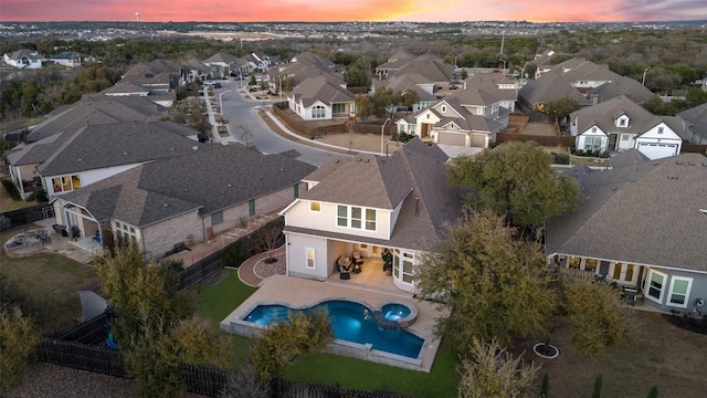 aerial view at dusk featuring a residential view