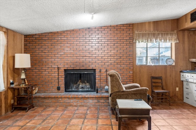 living room with brick wall, a textured ceiling, and wooden walls