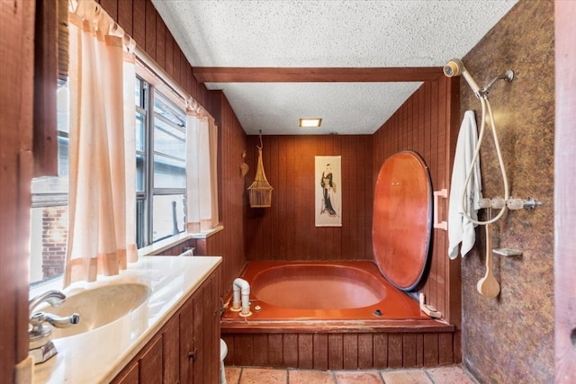 full bathroom with vanity, shower / bathing tub combination, a textured ceiling, and wooden walls