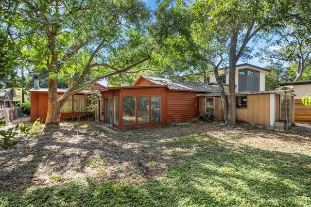 rear view of property with a yard