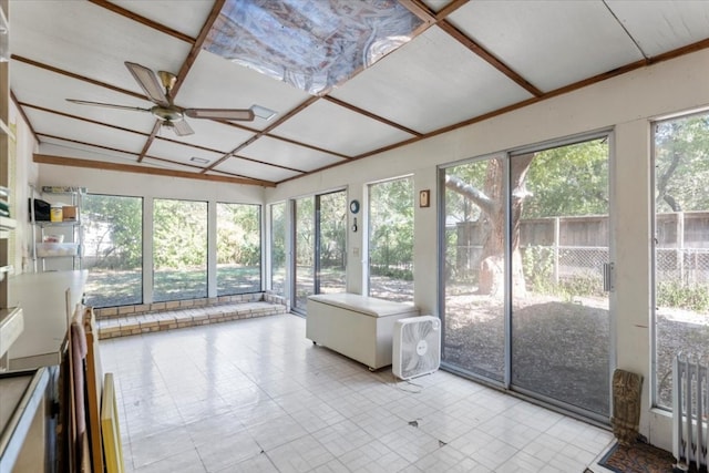 unfurnished sunroom with a healthy amount of sunlight, vaulted ceiling, and ceiling fan