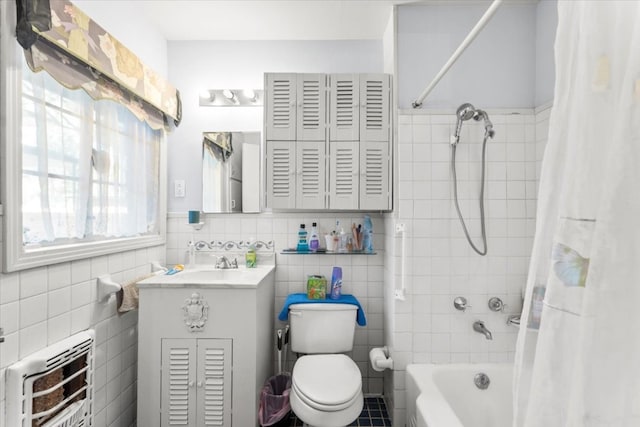 full bathroom featuring radiator heating unit, shower / bath combination with curtain, tile walls, toilet, and vanity