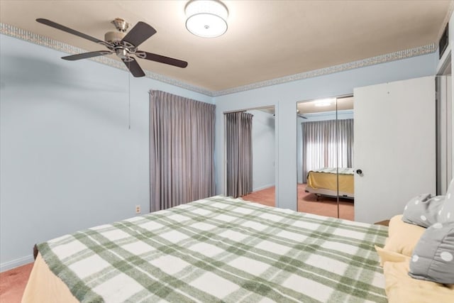 carpeted bedroom with ceiling fan and multiple closets