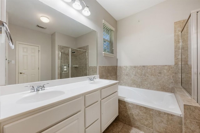 bathroom featuring vanity, tile patterned flooring, and separate shower and tub