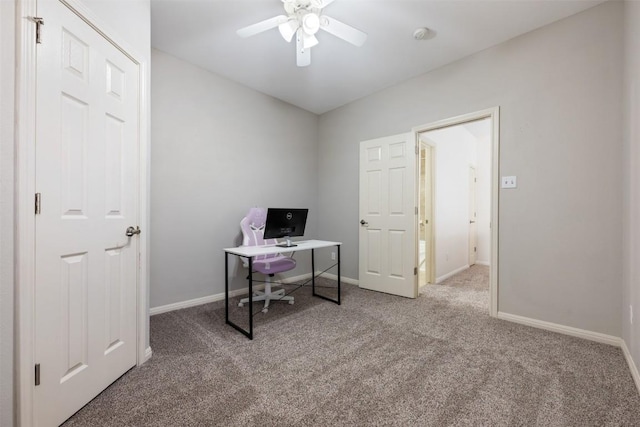 carpeted office space featuring ceiling fan