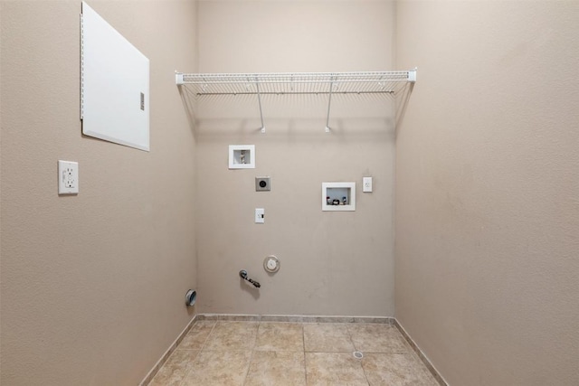 laundry area with hookup for a gas dryer, electric dryer hookup, washer hookup, and light tile patterned floors