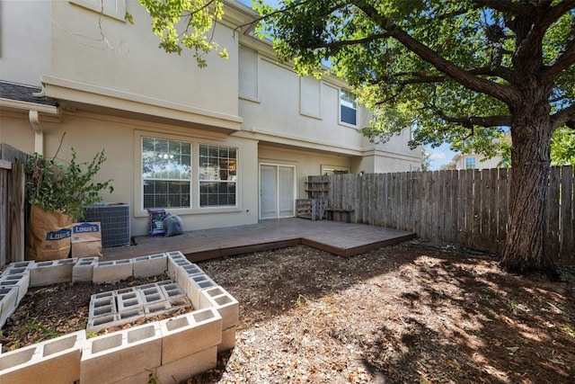 back of house with central AC and a deck