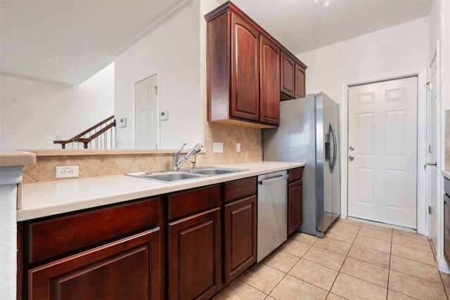 kitchen with sink, decorative backsplash, stainless steel dishwasher, and light tile patterned flooring